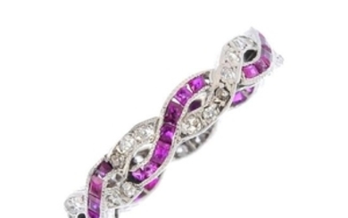 A ruby and diamond full eternity ring. Designed as two