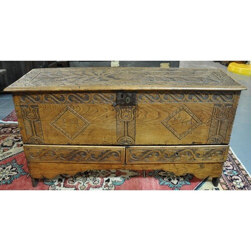 18th century oak plank chest, the moulded hinged top ornatel...