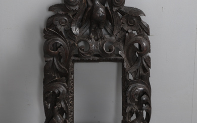A 19TH CENTURY CONTINENTAL CARVED OAK PICTURE/MIRROR FRAME.