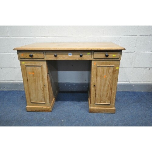 A 19TH CENTURY PINE PEDESTAL DESK, with three frieze drawers...