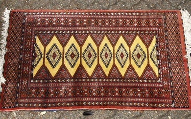 A 20TH CENTURY BOKHARA STYLE RUG, with yellow ground