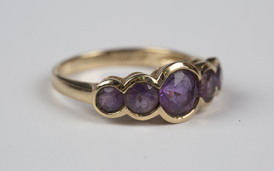 A 9ct gold and amethyst five stone ring, mounted with a row of graduated circular cut amethysts, wei