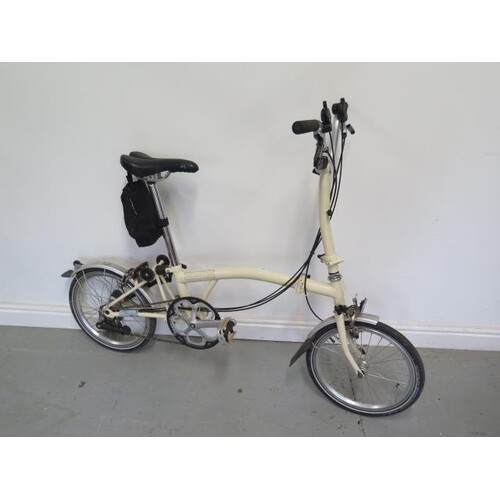 A Brompton folding bicycle with 16" wheels, lock and punctur...