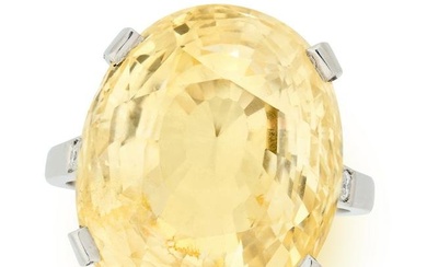 A CEYLON NO HEAT YELLOW SAPPHIRE AND DIAMOND RING set with an oval mixed cut yellow sapphire of