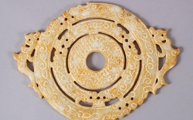 A CHINESE CARVED SOAPSTONE BI DISK, carved in archaic