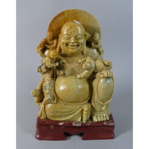 A Carved Soapstone Figure of Seated Smiling Buddha with Four...