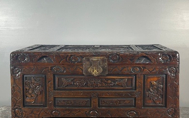 A Chinese carved camphor wood trunk, decorated with birds an...