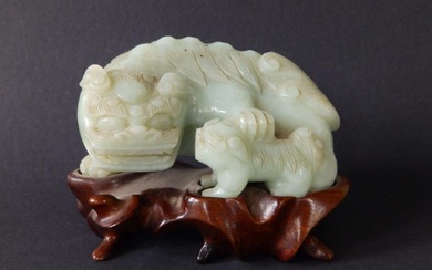 A Chinese celadon jade coloured stone carving of a...