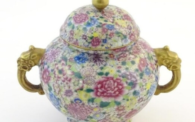A Chinese pot and cover with twin handles of stylised