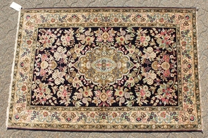 A FINE PERSIAN QUM SILK RUG, the centre with a pattern