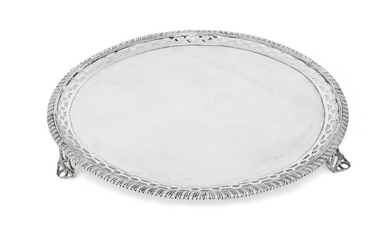 A George III Scottish silver salver, Edinburgh, 1773, Patrick Robertson, designed with pierced border and gadrooned edge, the base engraved with armorial (rubbed) and raised on three openwork bracket feet, 32.5cm dia., approx. weight 37.5oz