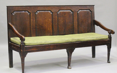 A George III oak settle with four panel back, on turned legs and pad feet, height 102cm, length 182c