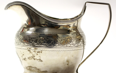 A George III silver cream jug, adorned with chased and engraved foliate band decoration