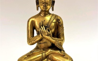 A Gilt Bronze Figure of Vairocana, Tibet, 16th Century.