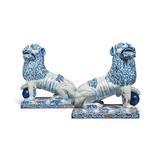 A LARGE PAIR OF CONTINENTAL FAIENCE BLUE AND WHITE MODELS OF LIONS, LATE 19TH/20TH CENTURY