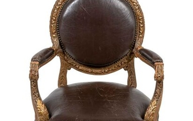 A Louis XVI Style Leather Upholstered and Parcel Gilt