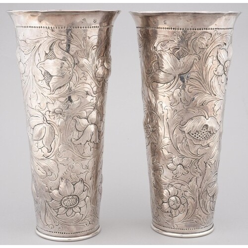 A PAIR OF SILVER REPOUSSE VASES OF TAPERED CYLINDRICAL SHAPE...