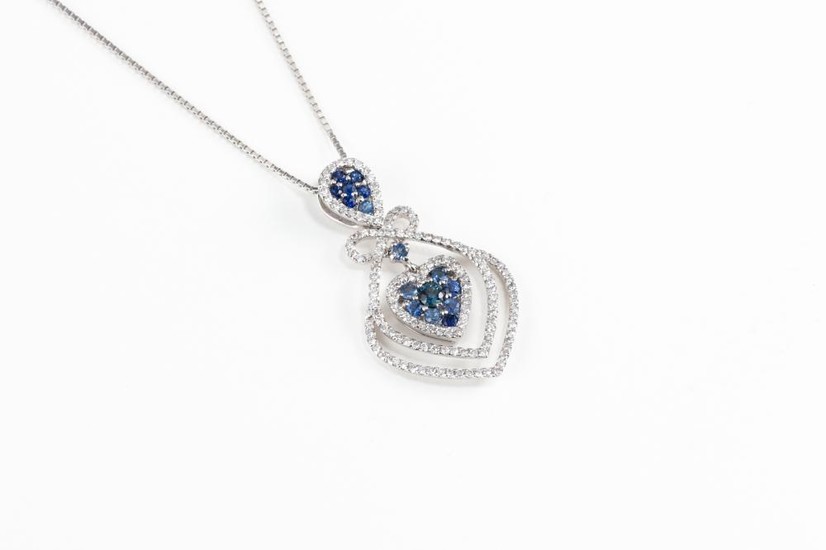 A SAPPHIRE AND DIAMOND HEART PENDANT NECKLACE; featuring an inverted pear shape and a heart shape cluster set with blue sapphires an...