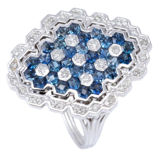 A SAPPHIRE AND DIAMOND RING; diamond shape 9ct white gold plaque set with round brilliant cut diamonds and hexagonal cut blue sapphi...