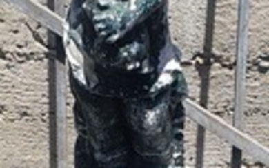 A STATUE OF A CHILD ON A PLINTH