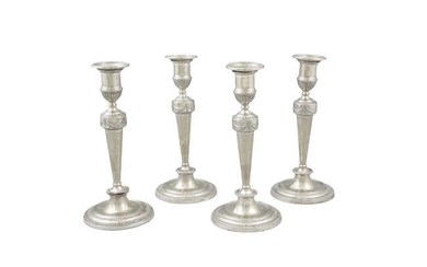 A SUITE OF FOUR SILVER PLATED TABLE CANDLESTICKS,...