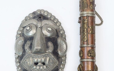 A Sino-Tibetan silver and brass inlaid copper scroll case, 19th/20th century, 21cm long, and a wood and white metal mask, 16cm high (2)
