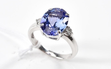 A TANZANITE AND DIAMOND RING-The oval cut tanzanite weighing 5.00cts, shouldered by round brilliant cut diamonds, in 18ct white gold...