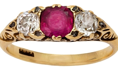 A Victorian ruby and diamond three stone half-hoop ring, the central cushion-shaped ruby flanked by two old-mine-cut diamonds with rose-cut diamond points to a carved gallery and shoulders, ring size O, c.1890