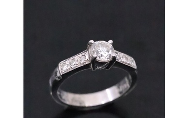 A diamond solitaire ring set in 18ct gold set with diamond s...