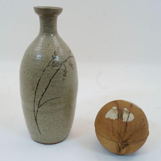 A glazed grey earthenware bottle vase, 20th century, decorated with wheat motif, unmarked, 29.2cm high, together with an ochre studio pottery globe form pot, the cover decorated with with daisies, maker's stamp to the footrim, 11cm high (2)