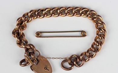 A gold curblink bracelet, detailed '9c', on a gold heart shaped padlock clasp, detailed