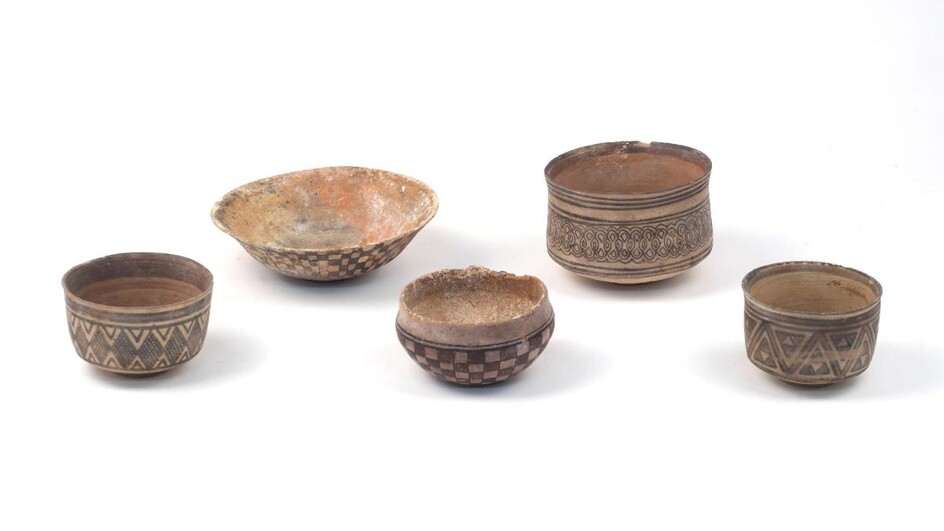 A group of modern Neolithic style bowls, of traditional form in terracotta, with hand-painted slip designs, of varying sizes, maximum 15.5cm diameter (5)