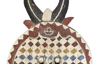 A large African Baule mask with red, white, black, yellow...