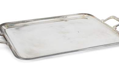 A large silver plated tray, by Christofle, of rectangular form with beaded edge and angular scrolling twin handles, 41.5cm wide, 65.7cm long (inc. handles)