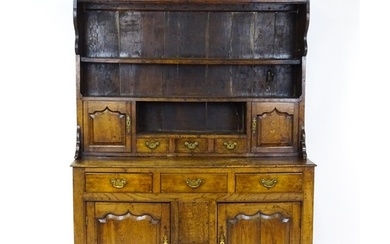 A mid 18thC oak dresser with a moulded cornice above three g...