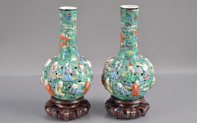 A pair of 19th Century Chinese famille verte relief moulded and reticulated porcelain bottle vases