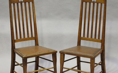 A pair of Edwardian Arts and Crafts oak framed side chairs, probably Scottish, the arched top rails