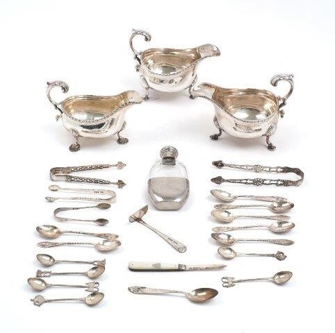 A pair of Edwardian silver gravy boats, Sheffield, 1906, James Dixon & Sons, on three pad feet, together with a smaller gravy boat, London, 1901, Charles Stuart Harris; a small quantity of silver and white metal spoons and sugar tongs, a glass hip...