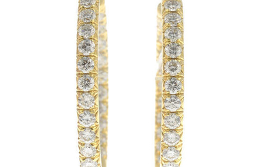 A pair of brilliant-cut diamond hoop earrings.