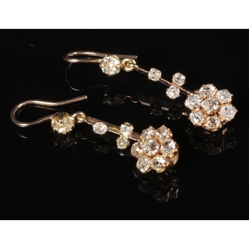 A pair of gold and diamond cluster drop earrings. Diamond we...