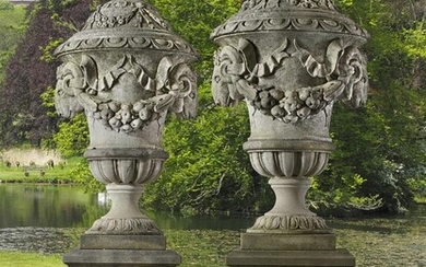 A pair of monumental Italian sculpted limestone urns in Neoclassical taste