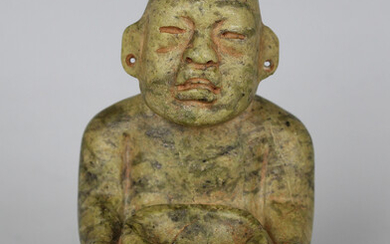 A pre-Columbian Olmec style carved green hardstone figure of a seated male, probably 900-450 BC, fin