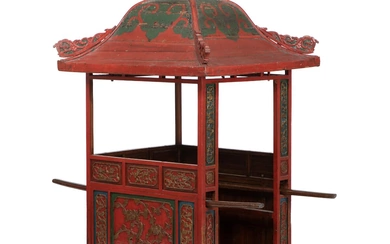 A richly carved ceremonial Chinese palanquin, red-lacquered and partially gilded. Late 19th...