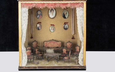 A room setting display case with ‘silver’ white metal filigree dolls’ house furniture