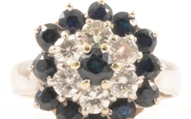 A sapphire and diamond reverse cluster ring.