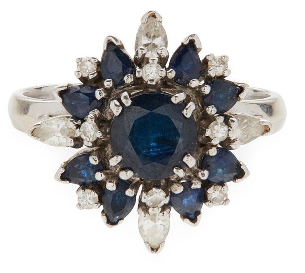 A sapphire and diamond set cluster ring claw set with...