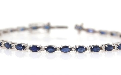 A sapphire bracelet set with numerous oval-cut sapphires weighing a total of...