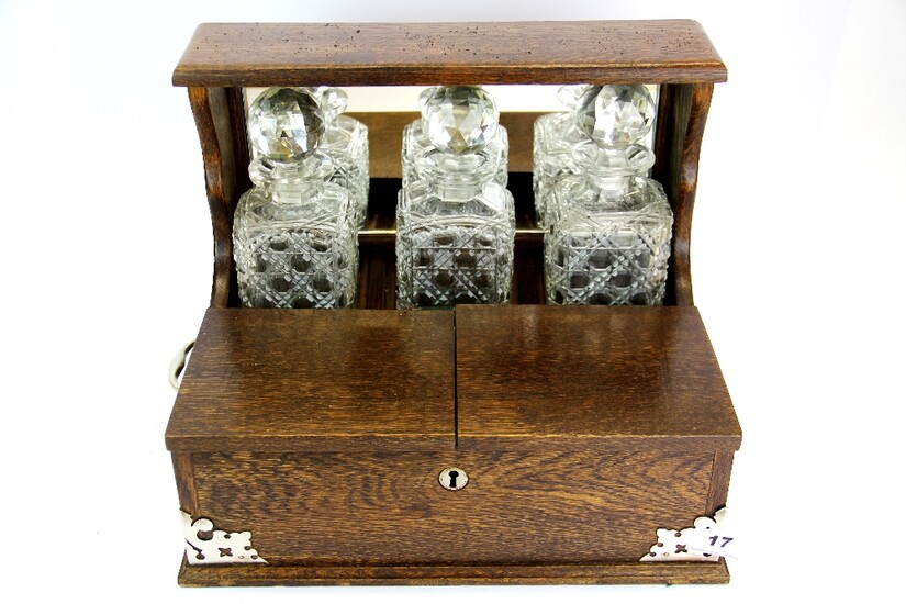 A three bottle oak tantalus with silver plated handles, 36 x 26 x 29cm.