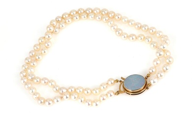 A two strand pearl necklace set with numerous cultured pearls and an...
