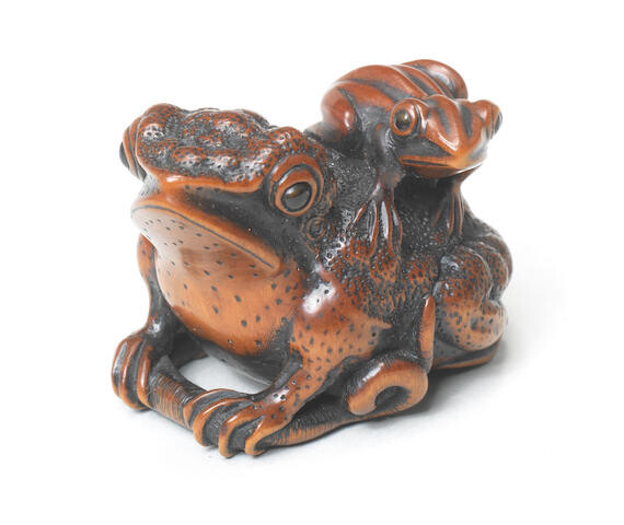 A wood netsuke of a toad and young